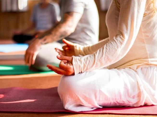 Guests meditating on yoga mats