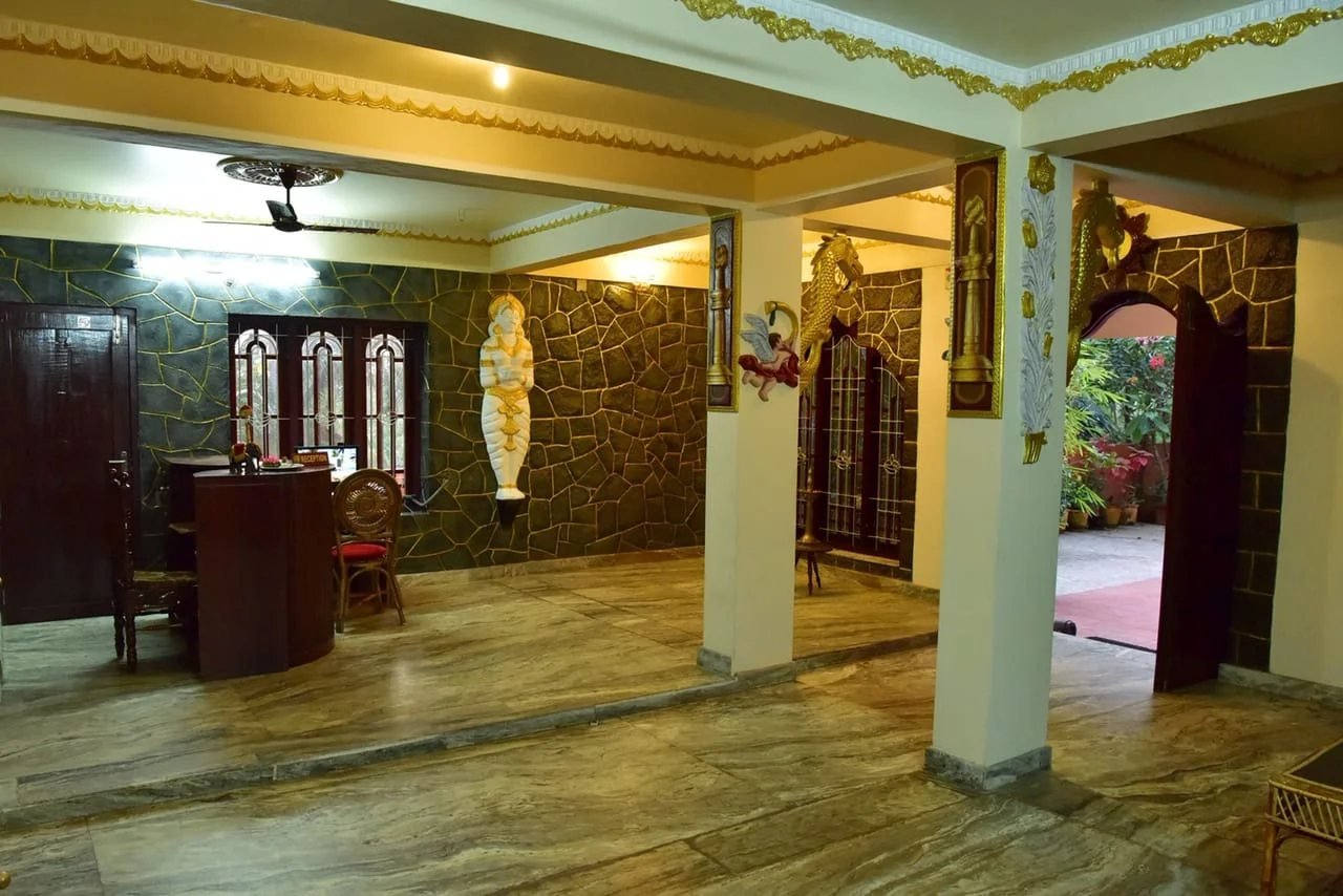 Lobby with stone-clad walls and carved pillars